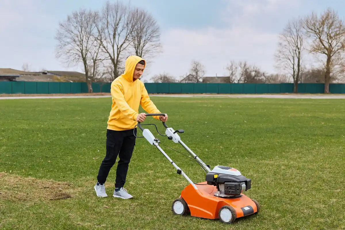 Close-up of lawn mower cutting grass at optimal height
