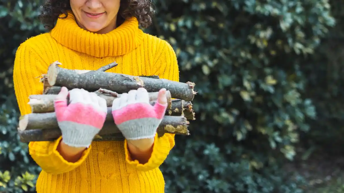 Close-up garden gloves in use with wet soil