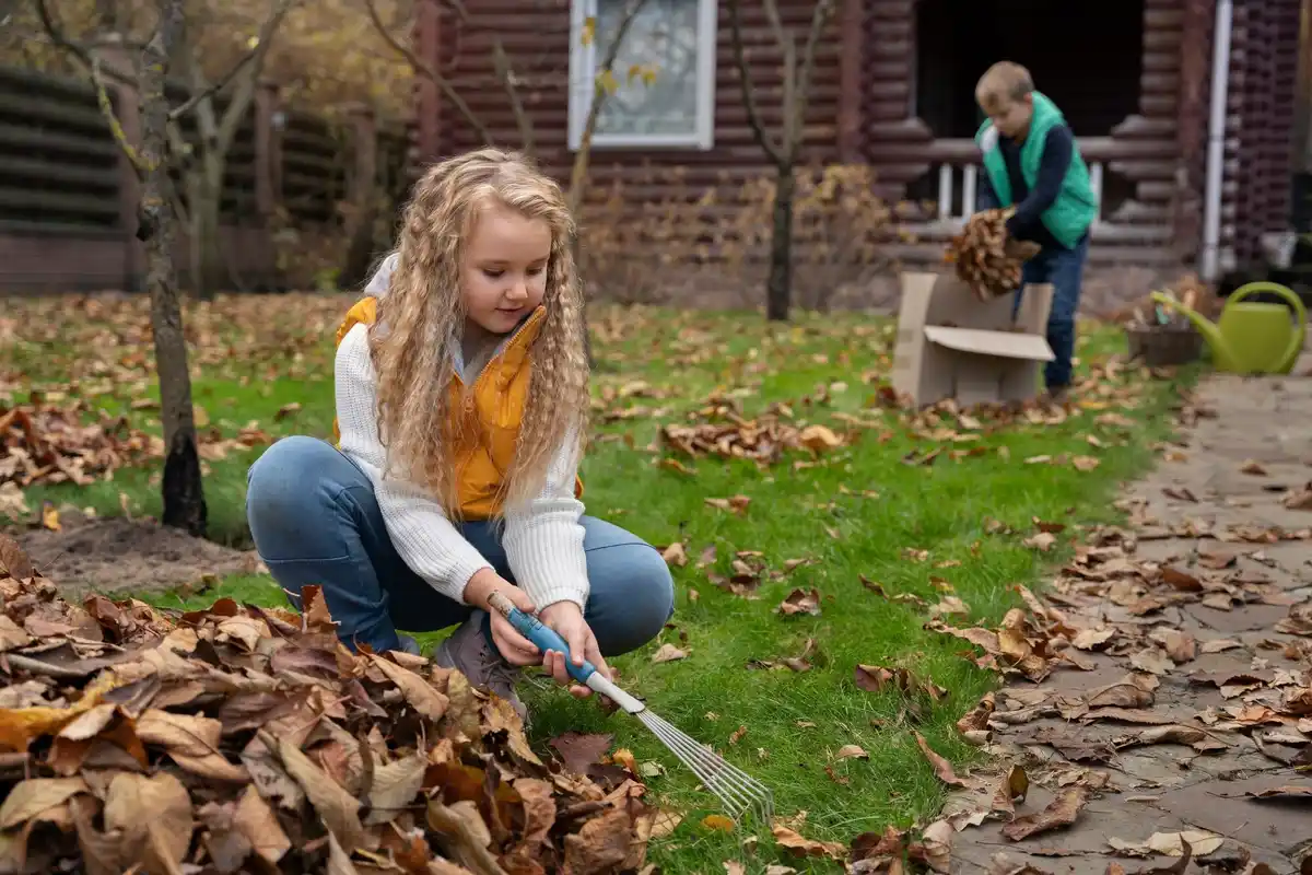 dutch gardener using garden fork to aerate soil