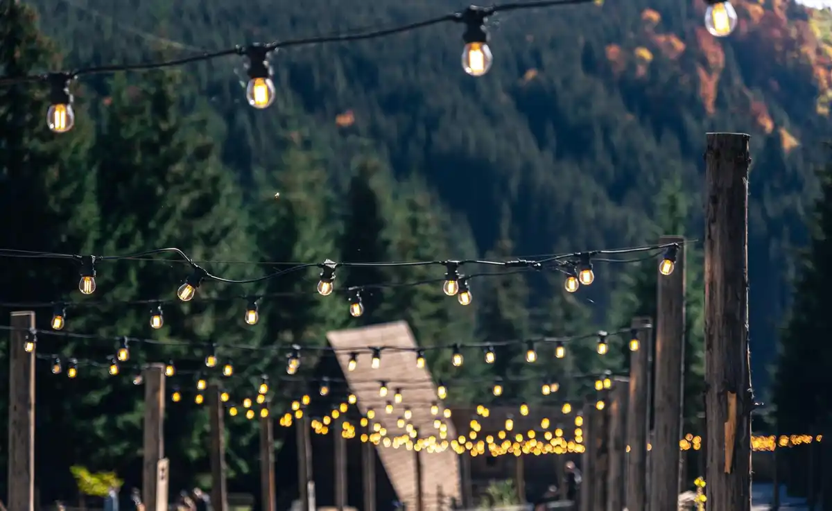 garden string lights at sunset, cozy backyard lighting, outdoor relaxation vibe